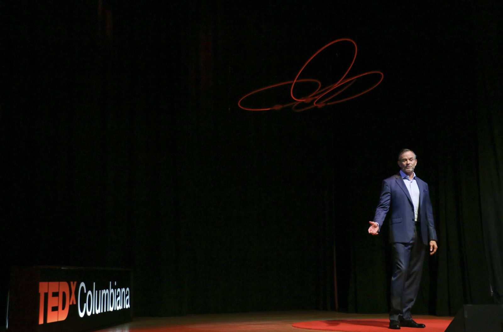 Dr. Jason Giles speaking on stage at TEDxColumbiana